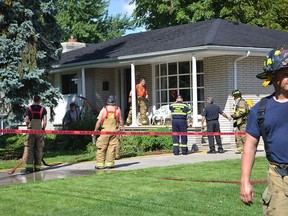 Amherstburg firefighters clean up after extinguishing a fire that started in the basement of a house on St. Arnaud Street in Amherstburg on Tuesday, Sept. 16, 2014. (JULIE KOTSIS/The Windsor Star)