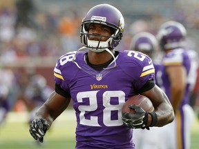 Minnesota Vikings running back Adrian Peterson (28) warms up before a NFL preseason football game in this August 2014 file photo. (AP Photo/Ann Heisenfelt)