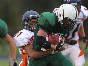 Belle River Nobles runningback Sean Brannagan is tackled by Sandwich Sabres defender Hamzah Iqbal during first half senior high school football action at Sandwich Secondary School in LaSalle, Ontario on September 11, 2014.  (JASON KRYK/The Windsor Star)