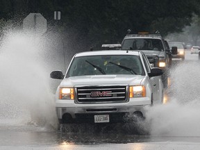 A truck drives through a flooded section of California Ave. near Norfolk after heavy rains hit the area on Wed. Sept. 10, 2014. (DAN JANISSE/The Windsor Star)