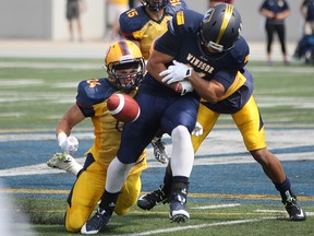 Windsor wide receiver, Dylan Whitfield fumbles the ball after a reception against Queen's in their OUA football season opener at Alumni Field, Monday, Sept. 1, 2014.  (DAX MELMER/The Windsor Star)