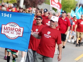 UNIFOR members walk down Walker Rd. for the Labour Day parade, Monday, Sept. 1, 2014.  (DAX MELMER/The Windsor Star)