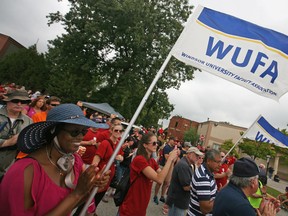 Workers with the Windsor University Faculty Association stand front and centre during speeches for Labour Day at the Fogolar Furlan, Monday, Sept. 1, 2014.  (DAX MELMER/The Windsor Star)