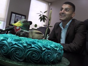 Windsor mayor Eddie Francis presents a lame duck cake during a media availability session regarding city council's lame duck session, Friday, September 12, 2014.  (DAX MELMER/The Windsor Star)