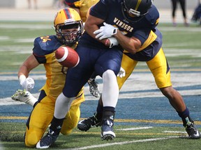 Windsor wide receiver, Dylan Whitfield, fumbles the ball after a reception in the OUA football season opener against  Queen's  Sept. 1, 2014.   Windsor’s 39-30 loss will now go in the books as a 1-0 win for the Lancers after Queen's was forced to forfeit because of a player's academic ineligibility.
(DAX MELMER/The Windsor Star)