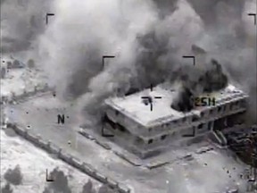 This still image made from video released by the U.S. Central Command on Tuesday, Sept. 23, 2014, shows a structure in Tall Al Qitar, Syria moments after a U.S. airstrike. In three waves of nighttime attacks launched over four hours early on Tuesday, the U.S. and its Arab partners made more than 200 airstrikes against roughly a dozen militant targets in Syria. (AP Photo/US Central Command)