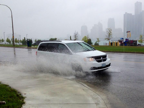 Heavy rain causes puddles along Riverside at Louis Ave. (NICK BRANCACCIO/The Windsor Star)