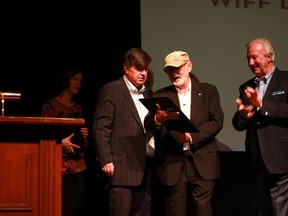 Norman Jewison reads the inscription on the plaque of his lifetime achievement award, presented to him by the Windsor International Film Festival on Saturday, September 20, 2014. (JAY RANKIN/The Windsor Star).