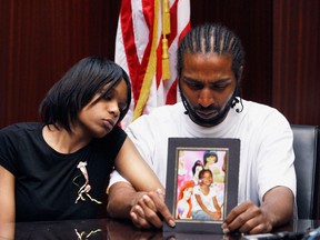 In this May 18, 2010 file photo, Dominika Stanley, left, the mother of 7-year-old Aiyana Jones sits next to Aiyana's father Charles Jones in attorney Geoffrey Fieger's office in Southfield, Mich. (Associated Press files)