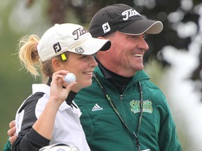 Heather MacKenzie, left, with St. Clair coach Kevin Coriveau in 2013, has rejoined the Saints golf team as an assistant coach. The women's team is tanked second in the nation by the CCAA. (JASON KRYK/ The Windsor Star)