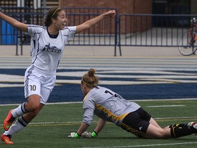 Windsor's Jaclyn Faraci, left, celebrates after scoring against Waterloo's Kianna Samuel-George during OUA women's soccer action at Alumni Field, Sunday, Sept. 21, 2014.  Windsor defeated Waterloo 2-1.  (DAX MELMER/The Windsor Star)