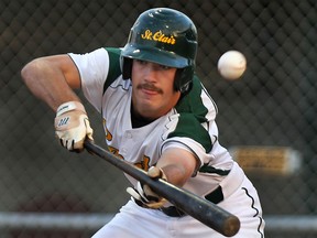 St. Clair College's Chris Horwood bunts Wed. Sept. 17, 2014, at the Lacasse Park against Fanshawe.  (DAN JANISSE/The Windsor Star)