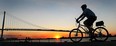 A cyclist cruises near the Ambassador Bridge on Wednesday, Sept. 3, 2014, as the sun set on warm summer day. (DAN JANISSE/The Windsor Star)