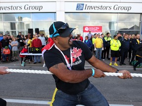 Ab Deo, from the Windsor RCMP team participates in the Ram Tough Truck Pull for United Way in downtown Windsor, Sunday, Sept. 21, 2014.  The event raised an estimated $45,000 for the United Way/Centraid Windsor-Essex County.  (DAX MELMER/The Windsor Star)