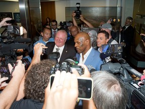 Toronto Mayor Rob Ford and Mike Tyson speak to media after a meeting between the two at Mayor Ford's office at City Hall in Toronto, Ontario on Tuesday, September 9, 2014.   (Laura Pedersen/Postmedia Newst)