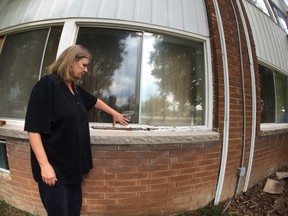 In this file photo, Brenda Brown stands outside her Meadowbrook Lane townhouse complex on Sept. 18, 2014.   Brown and other residents are upset with the condition of the building. (WINDSOR STAR PHOTO)