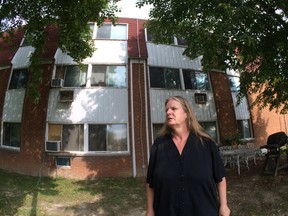 Brenda Brown stands outside her Meadowbrook Lane townhouse complex on September 18, 2014.   Brown and other residents are upset with the condition of the building. (WINDSOR STAR PHOTO)
