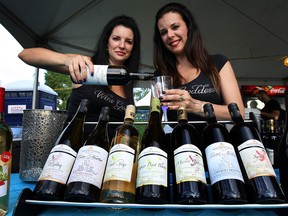 Laura Faust, left, and Dorothy Diewold of the Mastronardi Estate Winery pour a glass at the Shores of Erie International Wine Festival on Thursday, Sept. 4, 2014 in Amherstburg.(DAN JANISSE/The Windsor Star)