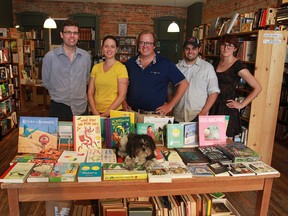 Jesse Eckerlin, left, Tara Murphy, Dan Wells, Chris Andrechek and Kate Hargreaves along with mascot Wesley make up the crew at Biblioasis on Wyandotte Street in Windsor. (JASON KRYK / The Windsor Star)