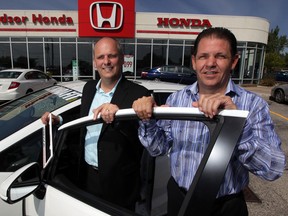 New owner Ken Eansor, left, poses with assistant general manager Mark Triembacher at Windsor Honda on Tecumseh Road East. Eansor has recently returned to Windsor and he and his staff are excited about Honda vehicles like the 2015 Honda Fit EX, shown in front. (NICK BRANCACCIO / The Windsor Star)