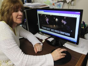 Iris House executive director Anne Ryan views a promotional video produced to raise mental health awareness. (JASON KRYK / The Windsor Star)