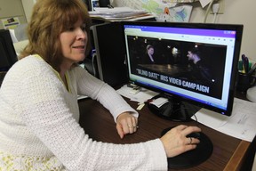 Iris House executive director Anne Ryan views a promotional video produced to raise mental health awareness. (JASON KRYK / The Windsor Star)