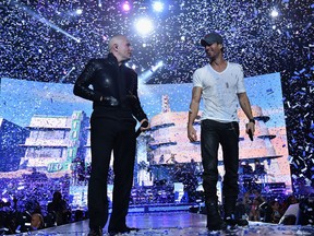 Pitbull, left, and Enrique Iglesias come to the Palace of Auburn Hills on Sunday, Sept. 21. (Theo Wargo / Getty Images)
