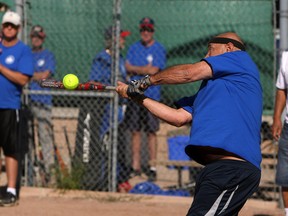 Frank Kotow makes contact during a recent senior's softball game at the Ciociaro Club in Windsor. (Tyler Brownbridge / The Windsor Star)