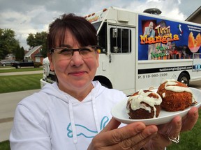 Sandi Bertram displays tasty rice balls, or arancini, served from the window of Tutti Mangia Twisted Italian Cuisine food truck. (NICK BRANCACCIO / The Windsor Star)