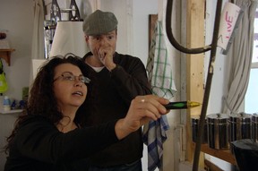 Steve Patterson, host of the new HGTV Canada show I Wrecked My House, with homeowner Naomi, who doesn't seem too concerned about having a live wire dangling in the middle of her kitchen. (Observe the note labelled "LIVE.")