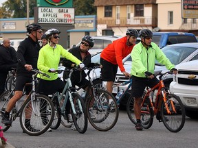 Led by Ross Mele, right, a local cycling group prepare for an evening tour starting at Jose's on Howard Avenue Wednesday October 1, 2014. (NICK BRANCACCIO/The Windsor Star)