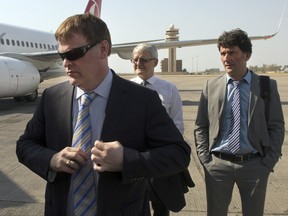 In this file photo, Canadian Foreign Affairs Minister John Baird (left), Liberal MP Marc Garneau, (centre) and NDP MP Paul Dewar, right, arrive at the airport, Wednesday, Sept. 3, 2014 in Baghdad, Iraq. THE CANADIAN PRESS/Ryan Remiorz ORG XMIT: RYR110