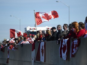 Supporters gather at Bankfield at the 416 to pay respect to Cpl. Nathan Cirillo, whose body was transported on the Highway of Heroes to Hamilton on Friday, Oct. 24, 2014. (James Park / Ottawa Citizen)