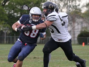 Windsor's Dan Jacobs, right, tackles London's Jason Kwon at Windsor Stadium in 2012. (DAX MELMER/The Windsor Star)