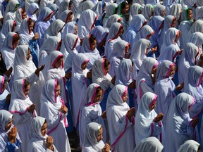 Pakistani students pray for child education activist Malala Yousafzai in celebration of Malala winning the Nobel Peace Prize, at a girls school in Malala's hometown Mingora in northwestern Swat valley on October 11, 2014. AFP PHOTO/ A MAJEEDA Majeed/AFP/Getty Images