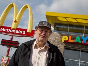 Ron Morais, who found a mouse in his McDonalds coffee, poses for a photo in front of the restaurant where it was purchased in Fredericton, Wednesday, Oct.15, 2014. THE CANADIAN PRESS/Keith Minchin
