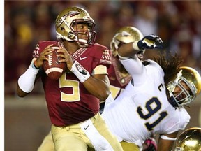 TALLAHASSEE, FL - OCTOBER 18: Jameis Winston #5 of the Florida State Seminoles escapes from Sheldon Day #91 of the Notre Dame Fighting Irish during their game at Doak Campbell Stadium on October 18, 2014 in Tallahassee, Florida. (Photo by Streeter Lecka/Getty Images)
Photograph by: Streeter Lecka/Getty Images