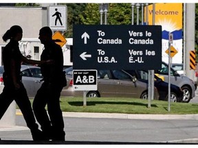Canadian border guards are silhouetted as they replace each other at an inspection booth at the Douglas border crossing on the Canada-USA border in Surrey, B.C., August 20, 2009. Frustrated by costly delays at the Canada-U.S. border, the business community is urging governments to seek solutions from private-sector whiz kids. THE CANADIAN PRESS/Darryl Dyck