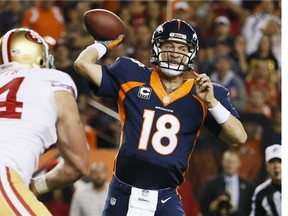 Denver Broncos quarterback Peyton Manning (18) throws against the San Francisco 49ers during the first half of an NFL football game, Sunday, Oct. 19, 2014, in Denver. (AP Photo/Jack Dempsey)