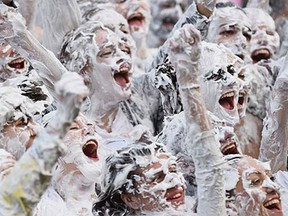 Students from St Andrew's University indulge in a tradition of covering themselves with foam to honour the 'academic family' on October 20, 2014, in St Andrews, Scotland. Every November the 'raisin weekend' which is held in the university's Lower College Lawn, is celebrated and a gift of raisins (now foam) is traditionally given by first year students to their elders as a thank you for their guidance and in exchange they receive a receipt in Latin.