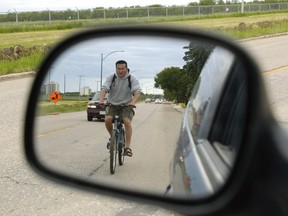 Double check that rear-view mirror — "dooring" a cyclist by knocking them off him off his bike with your coudl could soon cost up to $1,000 and three demerit points in Ontario.