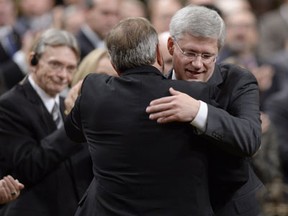 Prime Minister Stephen Harper hugs the Leader of the Opposition Tom Mulcair in the House of Commons on Thursday October 23, 2014 in Ottawa. THE CANADIAN PRESS/Adrian Wyld