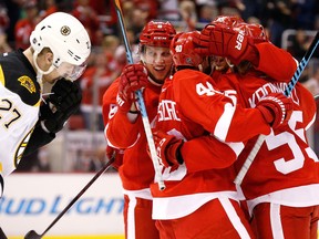 Detroit's  Justin Abdelkader, left, celebrates his goal as Boston's Dougie Hamilton skates by in the second period Thursday in Detroit. (AP Photo/Paul Sancya)