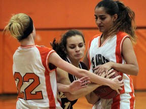 Leamington's Jocelyn Manning, centre, battles Tori Van Horn, left, and Natalie Arnouk of L'Essor in senior girls basketball action at L'Essor. (NICK BRANCACCIO/The Windsor Star)