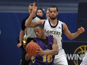 Windsor's Josh Collins, right, guards Laurier's Jamar Forde at the St. Denis Centre. (Dan Janisse/The Windsor Star)