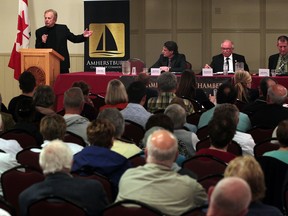 Amherstburg, ON. Oct. 16, 2014. Polished television personality, harness horsemen and local businessman Marty Adler, left, makes a point while answering a mayoral debate question at Amherstburg Chamber of Commerce event held at Verdi Club Oct. 16, 2014. Candidates Aldo DiCarlo, Ron Sutherland and John Sutton, right, listen and prepare for their turn at the microphone. (NICK BRANCACCIO/The Windsor Star)