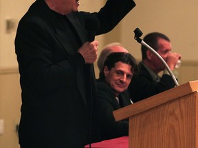 Polished television personality, harness horsemen and local businessman Marty Adler makes a point while answering a mayoral debate question at Amherstburg Chamber of Commerce event held at Verdi Club October 16, 2014.  Behind, candidates Aldo DiCarlo, Ron Sutherland and John Sutton, right, listen and prepare for their turn at the microphone. (NICK BRANCACCIO/The Windsor Star)