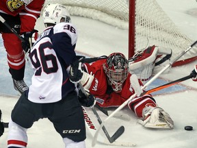 Windsor's Christiano DiGiacinto, left, tries to fire the puck past Owen Sound goalie Brandon Hope at the WFCU Centre. (TYLER BROWNBRIDGE/The Windsor Star)