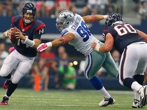 Windsor's Tyrone Crawford, centre, chases Ryan Fitzpatrick of the Houston Texans as Ben Jones blocks the Dallas Cowboys defensive lineman in the first half at AT&T Stadium in Arlington, Texas. (Photo by Tom Pennington/Getty Images)