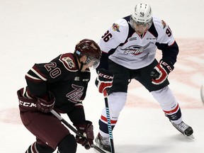 Windsor's Cristiano DiGiacinto, right, checks Nick Ritchie of the Petes at the WFCU Centre. (TYLER BROWNBRIDGE/The Windsor Star)